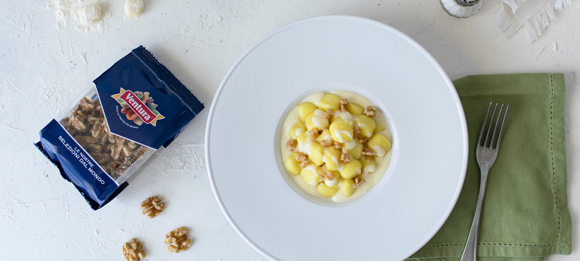 gnocchi al castelmagno e noci piatto bianco tovagliolo verde